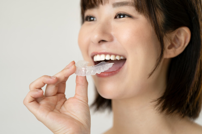 マウスピースを装着しようとしている女性